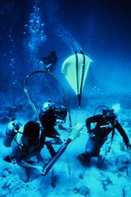 Scientists preparing to collect a core sample in a coral reef